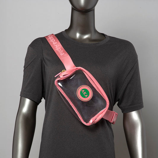 A pink clear crossbody bag with an AKA logo on the front. The strap is adjustable and has the letters "Kappa Alpha" printed on it.