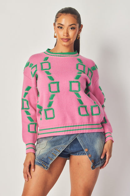 Woman wearing a pink and green geometric knit sweater