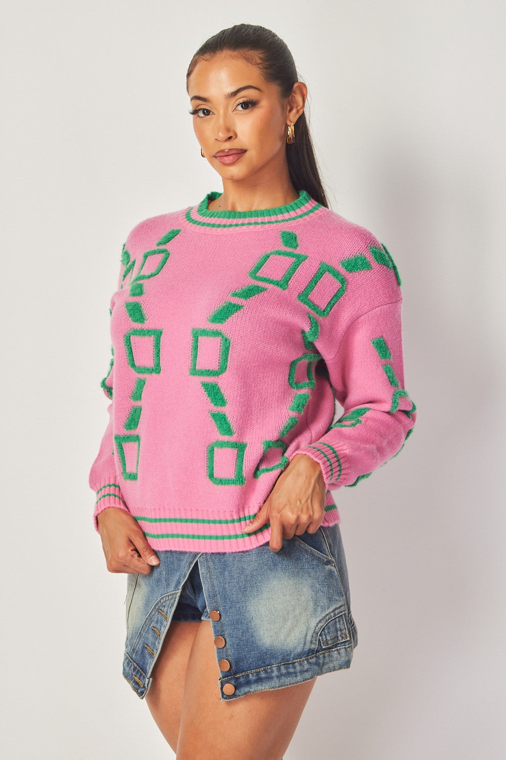 Pink sweater with green geometric design, front view