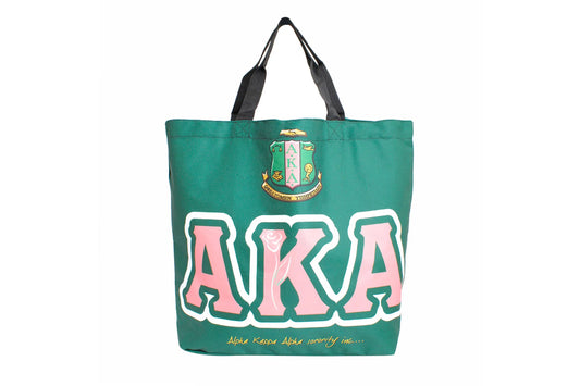 A close-up of the Alpha Kappa Alpha Sorority logo on a green tote bag. The logo features a shield with the letters "AKA" and a rose.