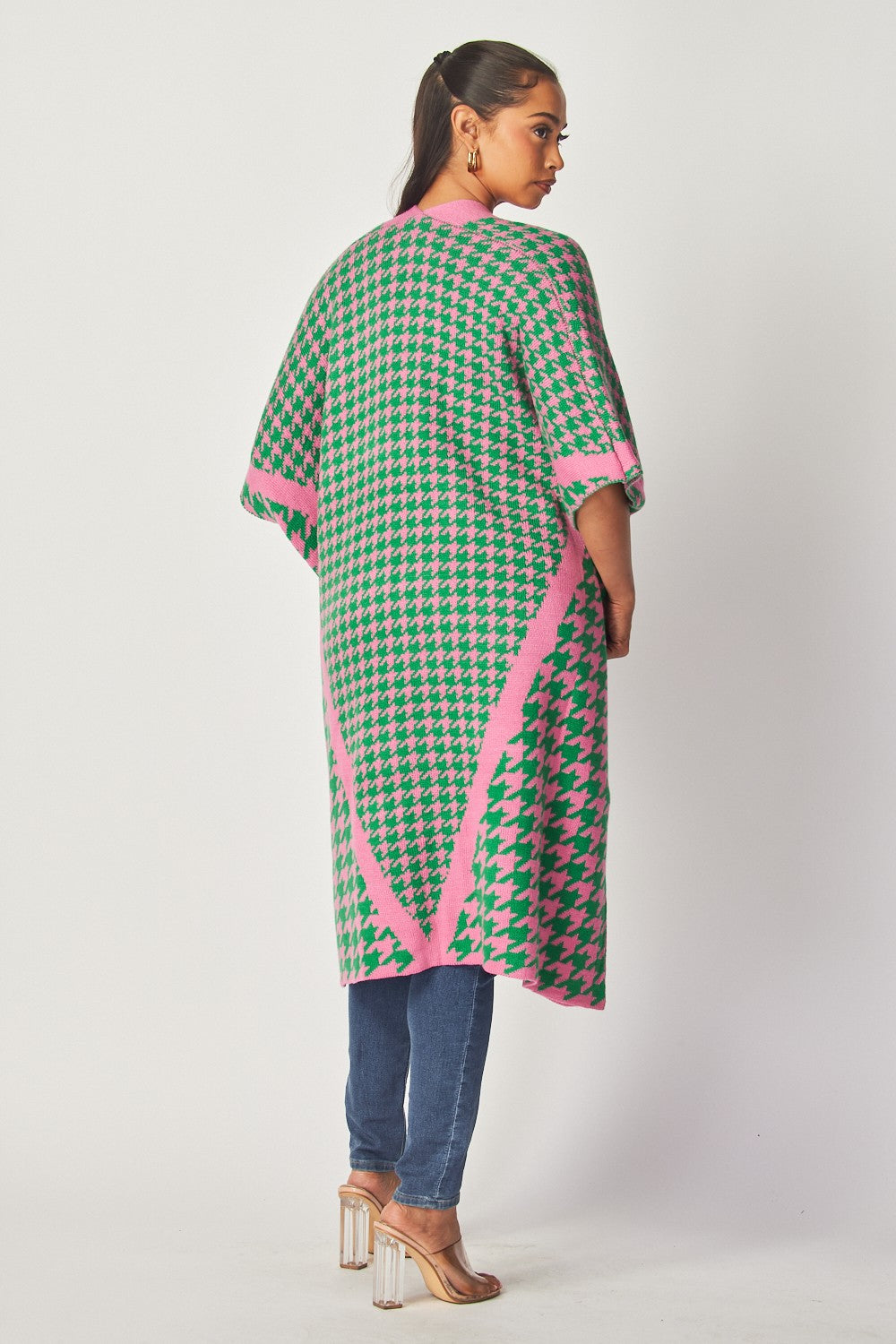 Warm houndstooth poncho with pockets, ideal for chilly days.