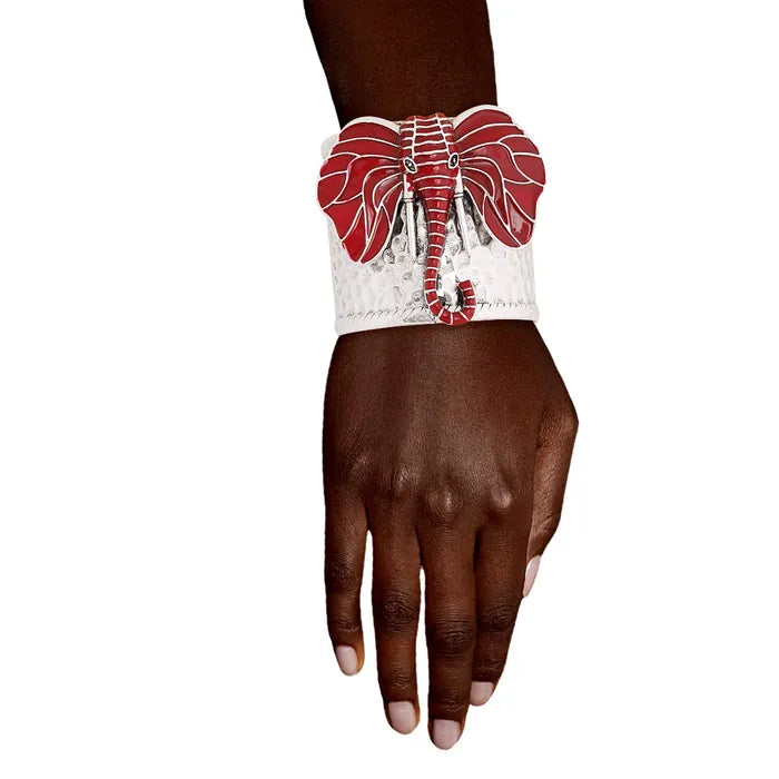 A woman wearing a red enamel elephant cuff bracelet on her wrist, supporting Delta Sigma Theta.